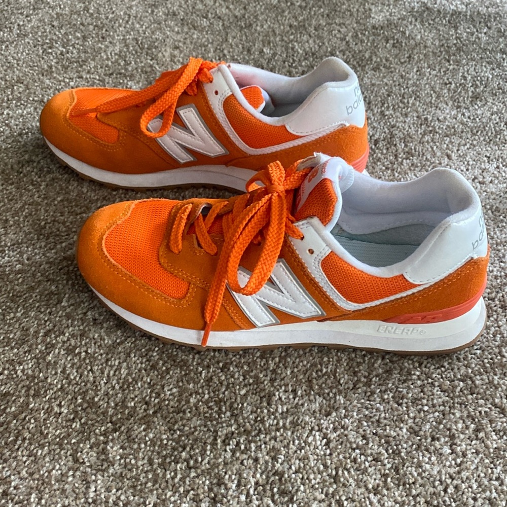 Orange and white new balance shoes